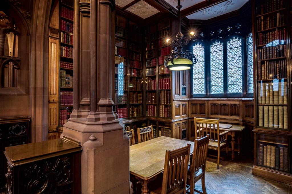 Reading room interior with bound books and warm light.