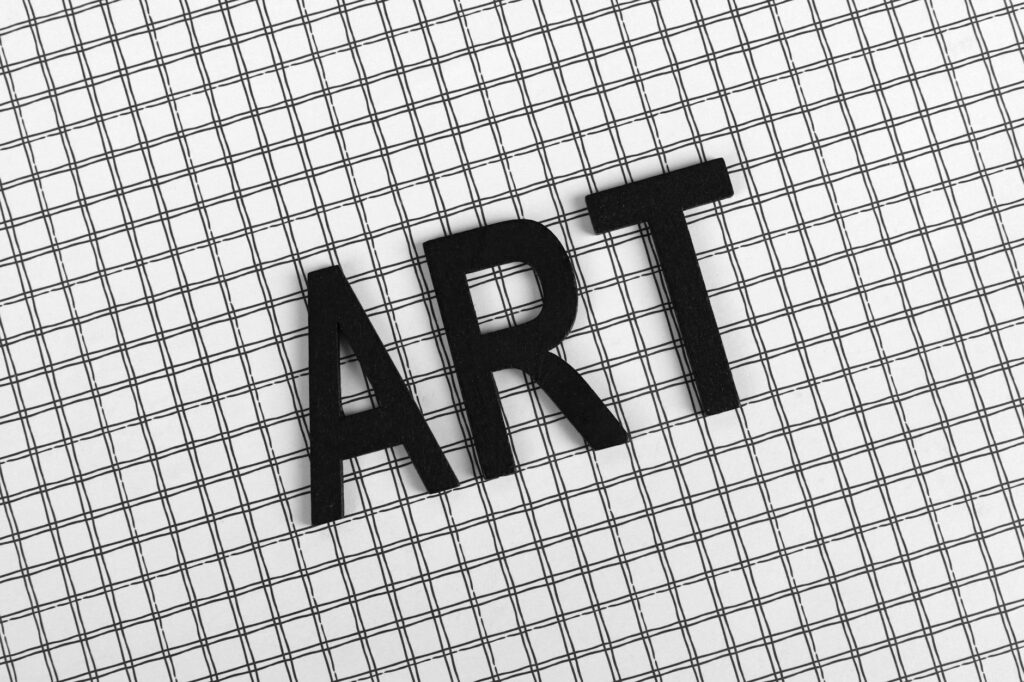 Minimal black-and-white typography arranged on a desk.