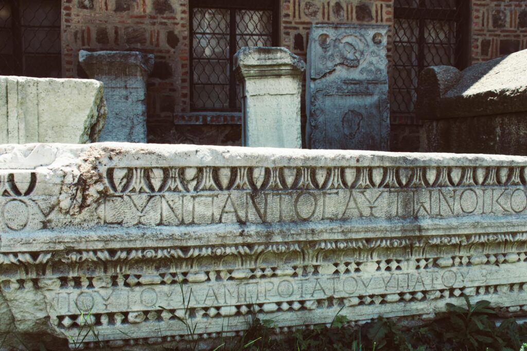 Carved Roman capitals on a stone monument, showing the proportions Trajan would later imitate.